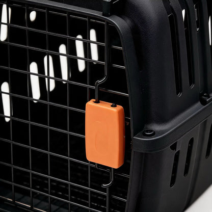 Detalj av sikkerhetslåsen på svart transportbur for katt